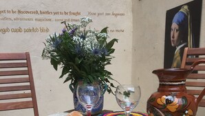 A table set with a vase, a jug, a plate, a candle, and a book. - A relaxed,  comfortable and cosy home (Chef Boutonne)