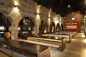 Experience the warm ambiance of Porto Calem in this rustic dining area, featuring stone arches and wooden beams.