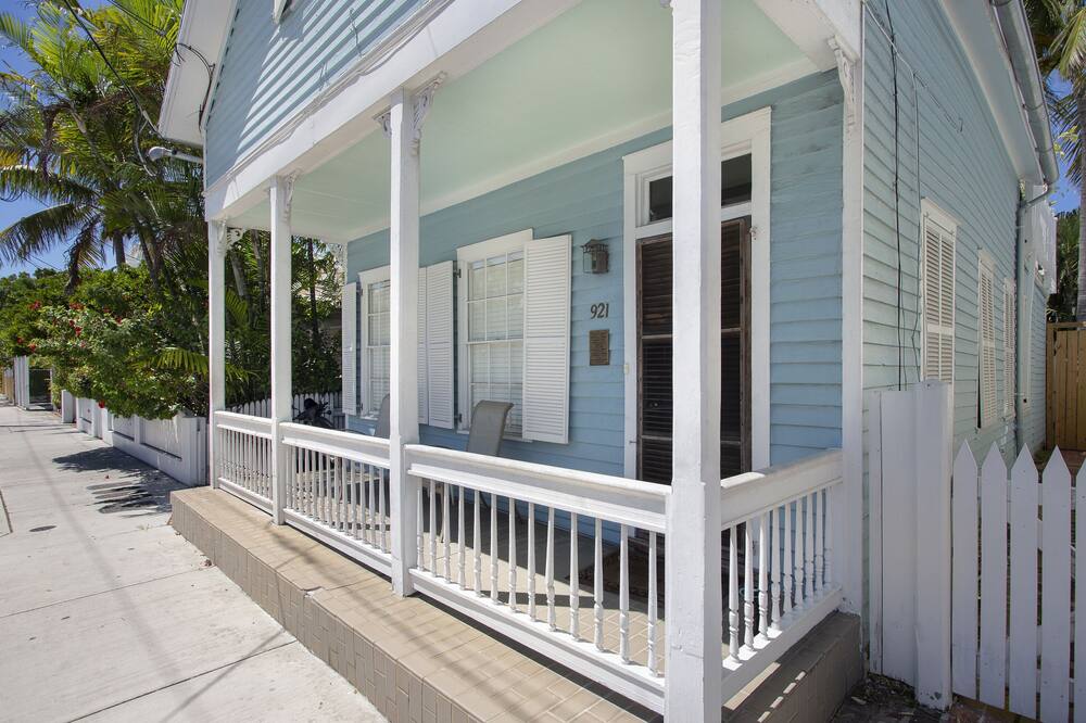 This traditional cottage, in the heart of Old Town, was built by a shipbuilder in the early 1900’s. It has all the charms of old Key West with all the modern amenities for any couple or family to have a memorable vacation. Wake up to the sweet smells of bread and pastries from the local bakery across the street. Eaton Street has a lot to offer with a live theater, bookstore, and the famous Tropic Cinema just a short walk away. The marina, with a number of restaurants and live entertainment, is only two blocks away. The Duval Loop free bus, which will take you to tourist sites and eateries has a stop just down the street. The house has three bedrooms. Two are located in the main house. The twin beds can be converted to a king. The other bedroom has a queen and private bath. Across from the house, past the pool and lounge chairs, is a one bedroom cottage with a king bed and bath. On the front porch of the cottage is a rocking chair where you can lose yourself sipping a margarita or hurricane and reading a good book. The backyard has a covered area with a table and chairs for outside dining even when one of the occasional rain showers comes by. There is a lush garden and palms that makes the pool and deck feel like a private oasis. The pool can be heated in cooler months and cooled in the heat of the summer. There is also a propane grill to cook the fish you catch on one of the many private boats available to go out deep sea fishing.<br><br>Families are welcomed in our vacation rentals. Student groups are not permitted. Our minimum age requirement to rent is 25 years old. Everyone in your party must be 25 years old to check in unless accompanied by a parent 3 bedroom 3 Bathroom house with a pool downtown near seaport