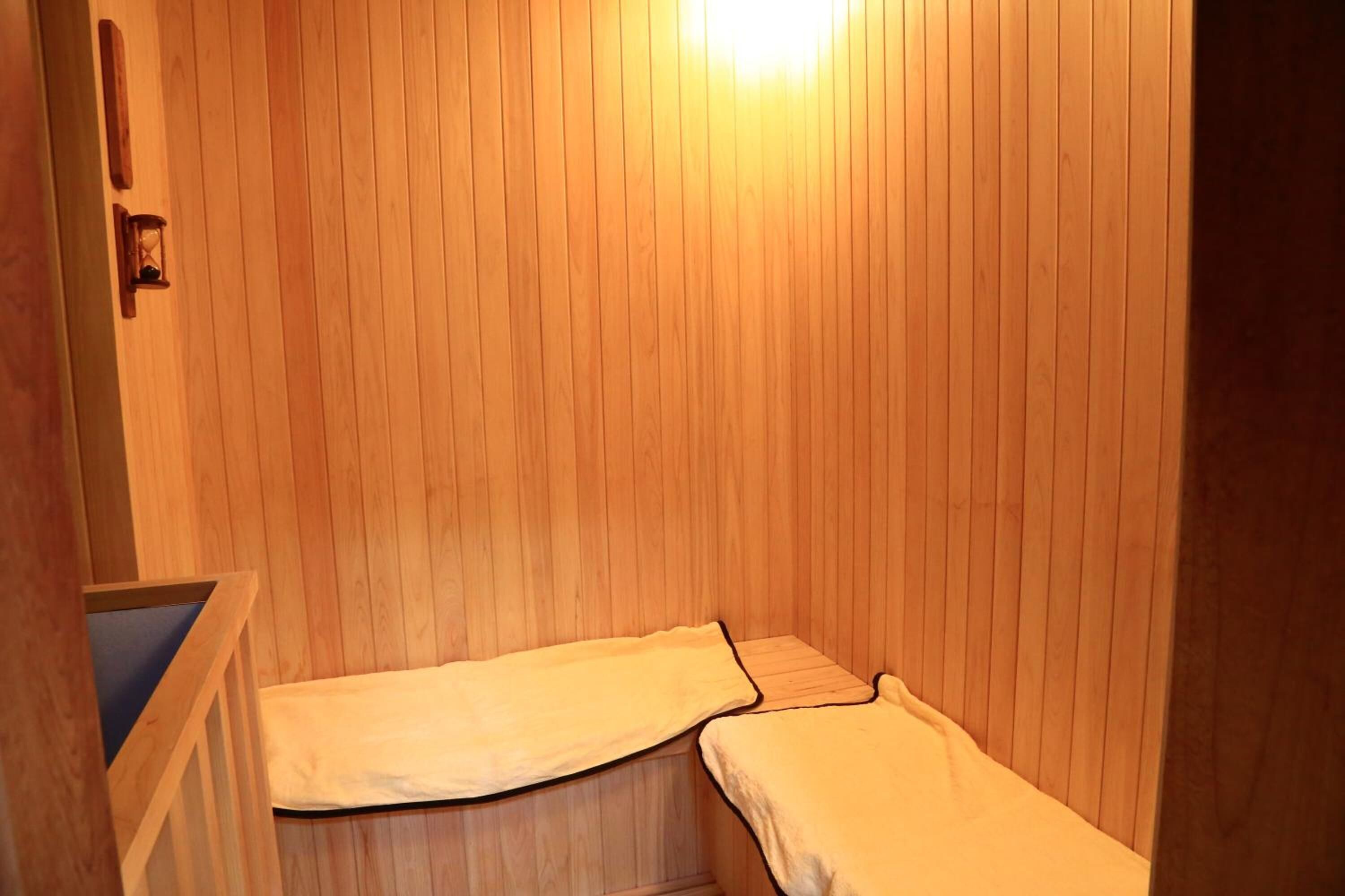 A small, wooden room with two beds.