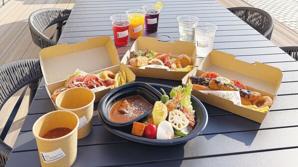 Une table dressée avec divers plats, boissons et condiments.