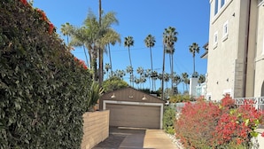 A residential driveway leading to a garage with a number 8020 garage door.