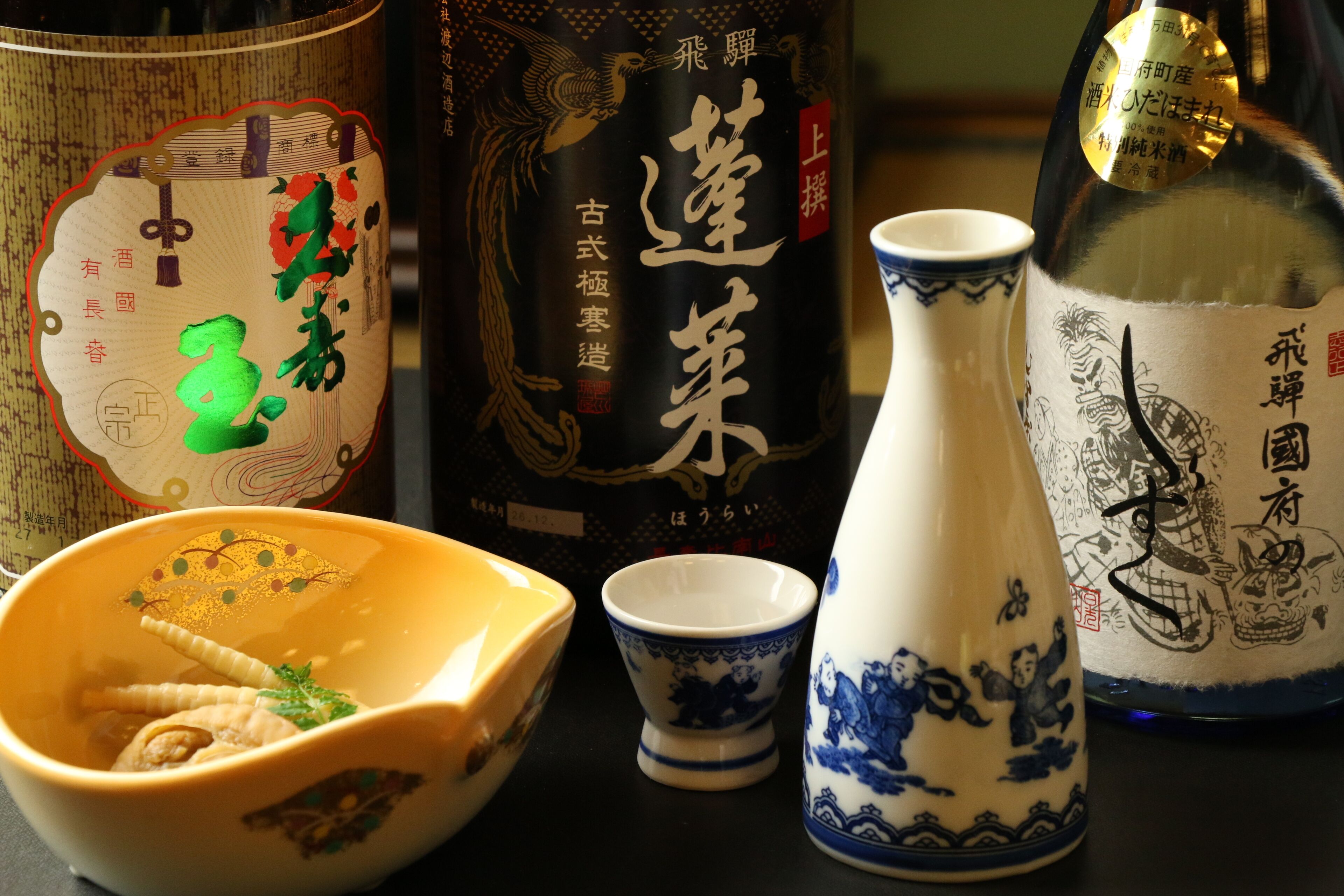 A collection of traditional Japanese ceramics and a bottle.