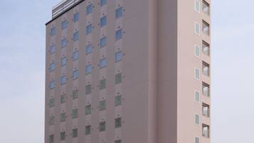 A tall, multi-story hotel with a flat facade and numerous windows.