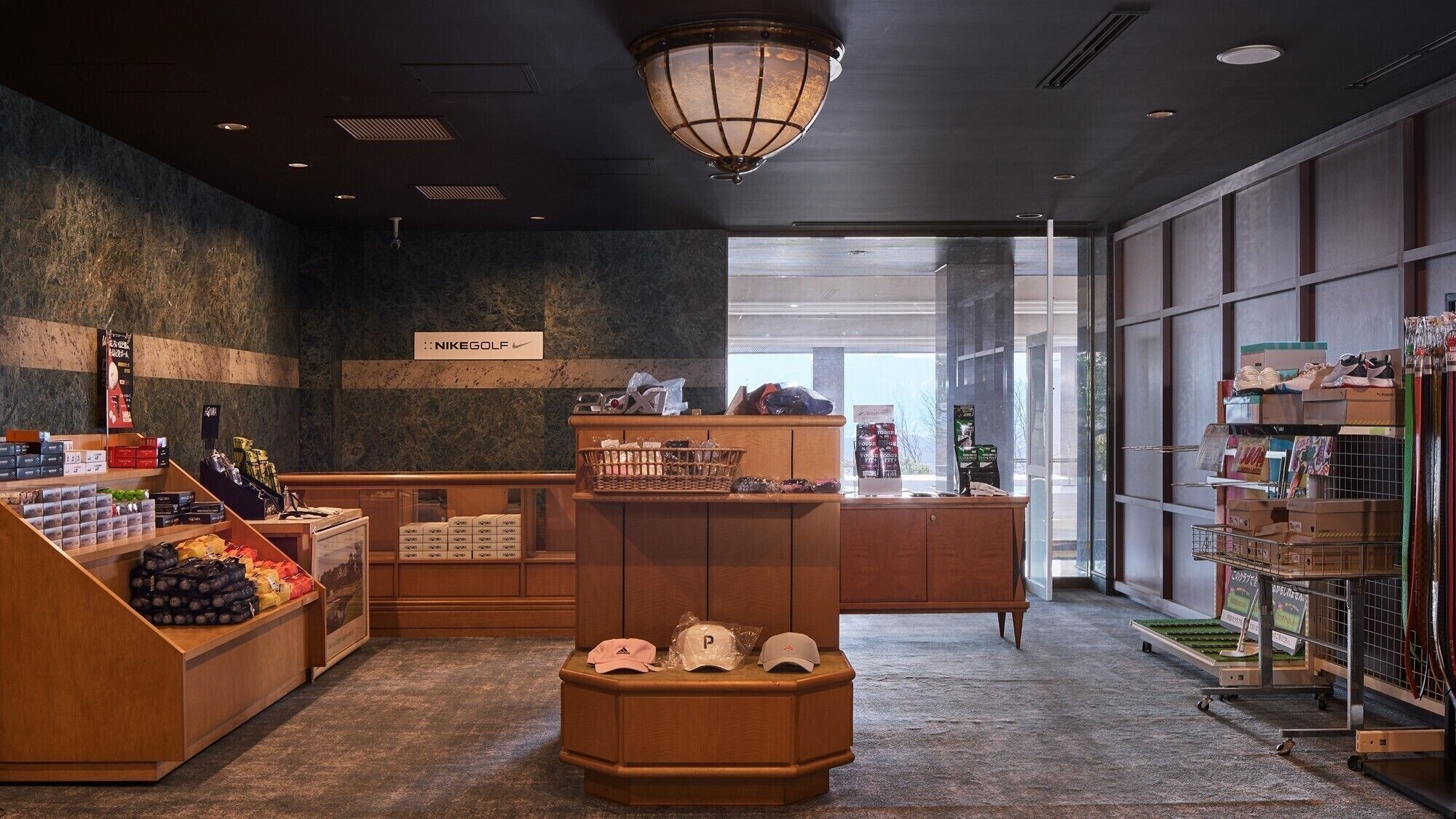 A retail space with wooden counters, a variety of packaged goods, and a NikeGolf sign.