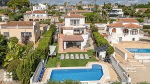 A residential area with a swimming pool, multiple houses, and lush greenery. - Villa RICA by Abahana Villas (Calpe)
