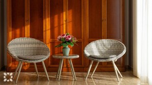 Two wicker chairs with cushions, a small round table, and a vase with flowers against a wooden backdrop. - Villa HAPPY FAMILY by Abahana Villas (Calpe)