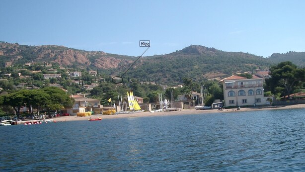 A coastal town with a beach, sailboats, and a large building with a balcony. - Splendid sea view for this Var house 350m from the sea in a private domain. (Saint-Raphaël)