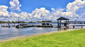 A marina with boats, a gazebo, and a water tower in the background. - Sundown B 13 (Pensacola)