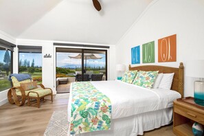 A spacious bedroom with a large bed, a balcony with a table and chairs, and a view of the outdoors. - Kapalua Golf Villas | Golf View 2 BR | Car Incl. w/ 6+ Nights | KGV-19P2 by KBM (Lahaina)