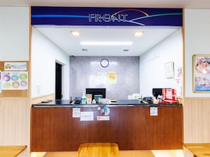 A reception desk with a sign that reads 'FRONT'.