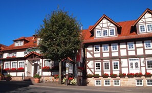 A traditional European building with a gabled roof, multiple windows, and flower boxes along the facade. - Parkhotel zum Stern (Oberaula)