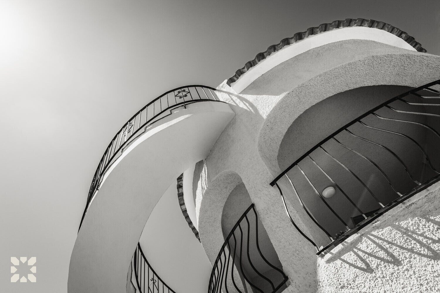 A spiral staircase with a railing, leading upwards in a modern architectural design.
