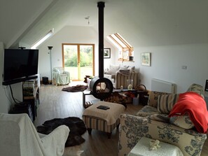 Een smart-tv, een open haard, boeken en een kantoor