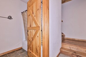 A wooden door with a cross design, a shower curtain, and a wooden staircase. - Crystal Clear Water, UTV Trail & Free Firewood! (Eagle River)
