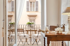 Enjoy a comfortable stay with a table for two, a cabinet, and a window with a view of the street outside.