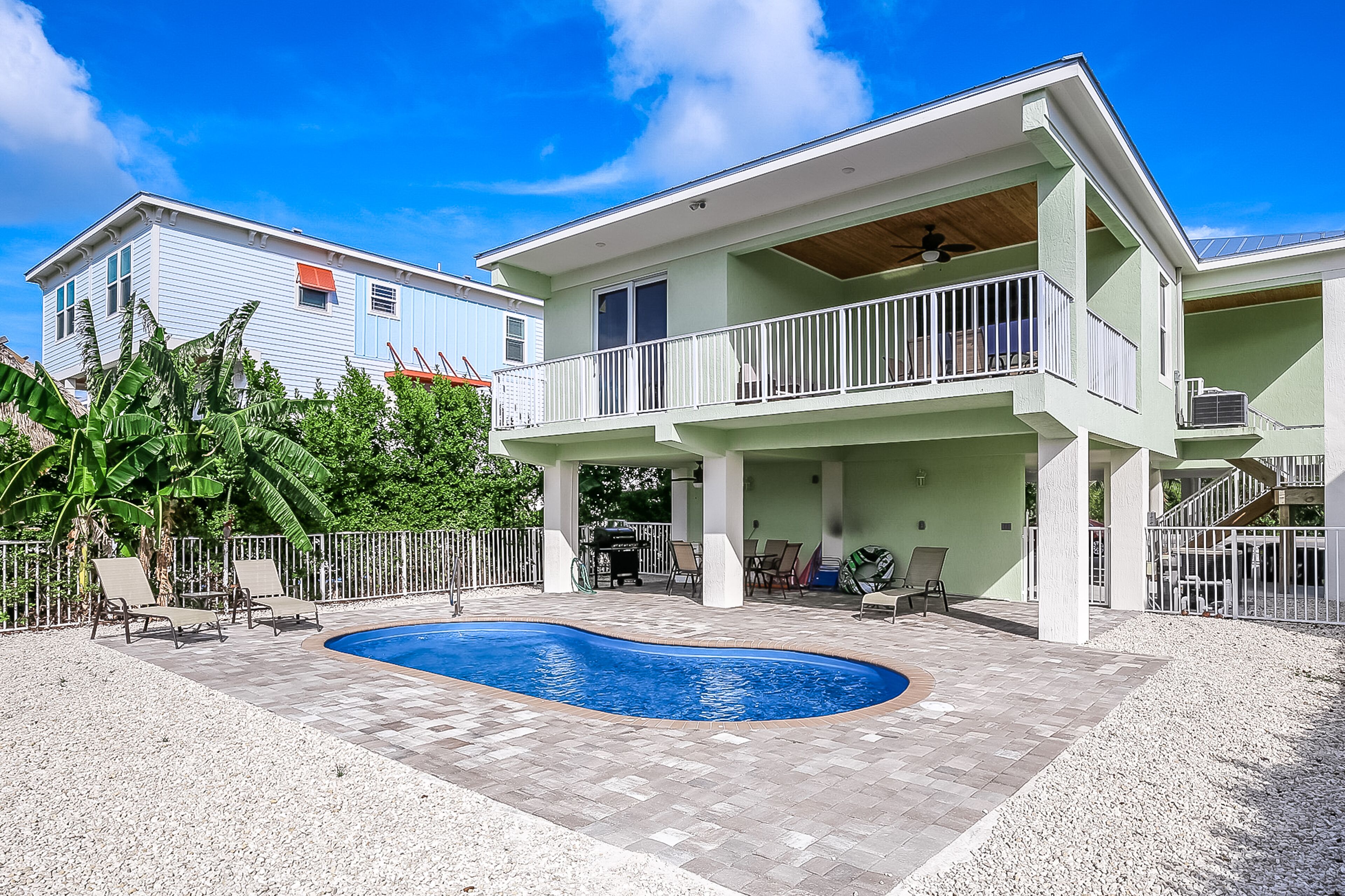 Waterfront home with spectacular view, pool, dock, & patio - walk to beach