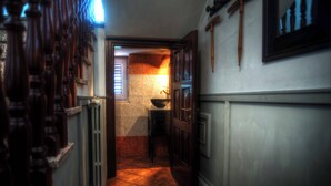 A narrow hallway with a tiled floor, wooden doors, and a window with blinds. - Sarkeep - Villa Immersed in the vineyards of Taurasi (Luogosano (Avellino))