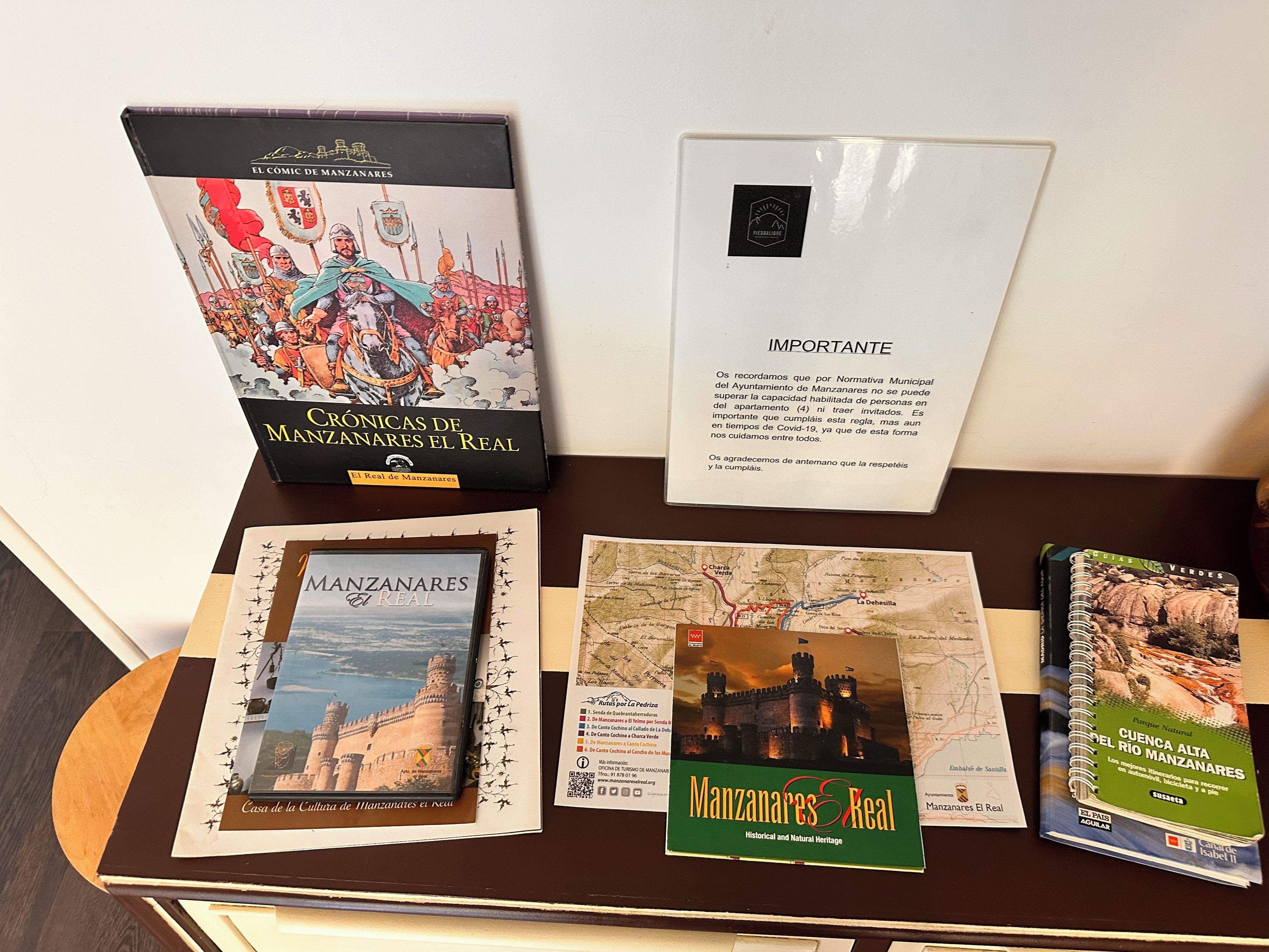 A display with informational materials about Manzanales, including a book, a map, and a sign.