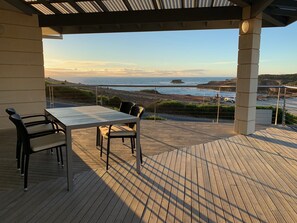 Enjoy a meal or a moment of peace on this outdoor patio with a stunning coastal view.