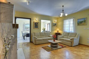 Relax in this inviting living space with a sofa, coffee table, and dining area.