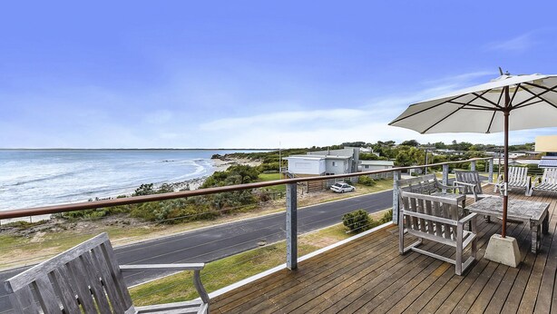 A wooden deck with outdoor furniture, overlooking a beach and ocean. - Bayview - Fantastic Panoramic Views of Guichen Bay - Pet Friendly Inside (Robe)