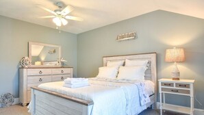 A bedroom with a bed, a dresser, a nightstand, a ceiling fan, and a wall-mounted shelf. - 400 Yards to the Beach! Dogs Welcome! (Dennis Port)