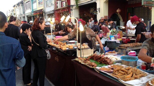 A street food market with various food stalls and people. - Phuket Town Budget Lodge AirconRoom1+Washer (Phuket)