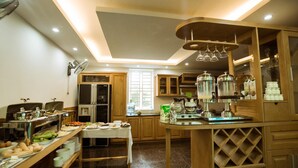 A modern kitchen with wooden cabinets, a dining table, and various kitchen appliances.