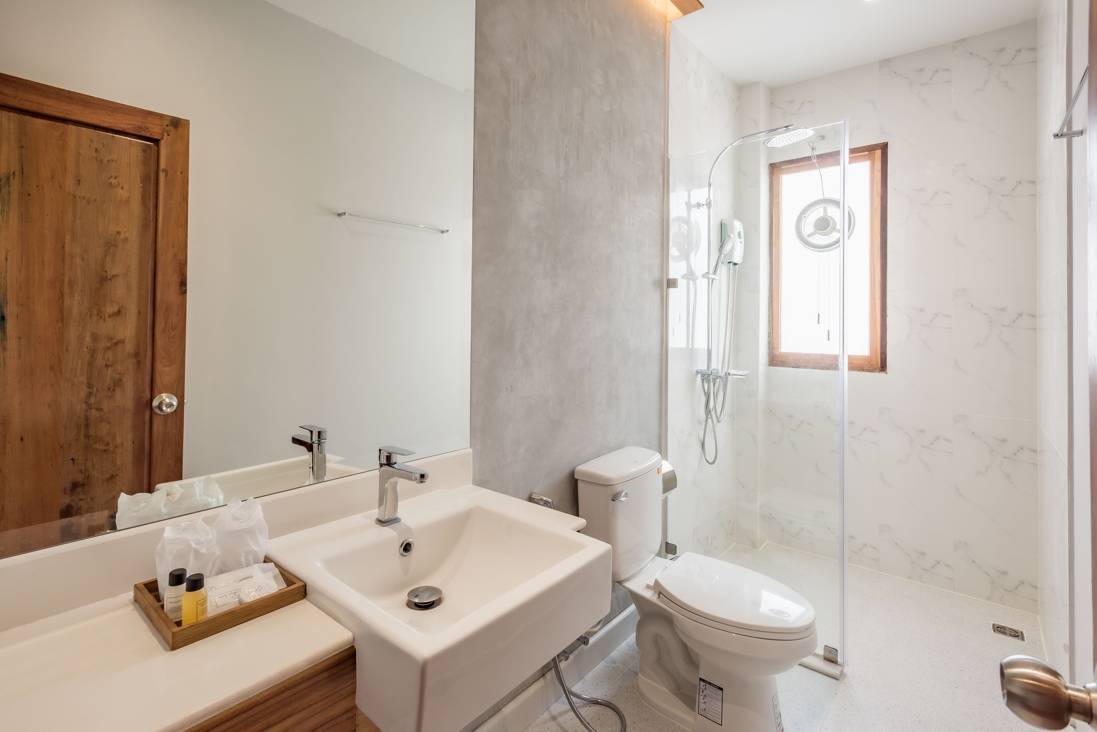 A bathroom with a sink, toilet, and shower.