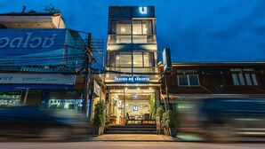 A modern building with a prominent 'U' sign on the top. - U Chiangkhan Hotel (Chiang Khan)