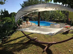 A hammock under a canopy, a pool, and outdoor furniture. - PRIVATE POOL ... PERFECT FOR HOSTING FRIENDS ... (mirabella eclano)