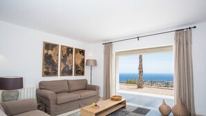 A modern living room with a sofa, coffee table, and artwork on the wall. - Villa ROSINA by Abahana Villas (Benissa)