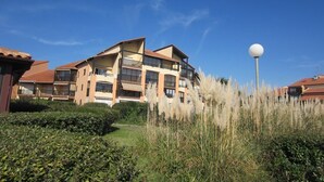 A multi-story residential building with balconies and a spherical street lamp. - Apartment for 6 persons with swimming-pool and tennis in condominium (Capbreton)