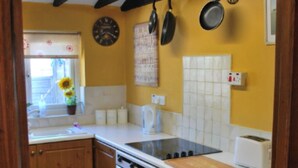 A kitchen with wooden cabinets, a stove, a sink, and a toaster. - COTTAGE SLEEPING 4 HAYSTACK/HAYLOFT NEXT TO FOX COVERT PUB YARM (High Leven)