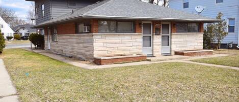 A two-story house with a brick facade and a flat roof.