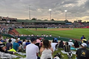 A baseball stadium with a green field, seating areas, and a crowd of spectators. - Studio apartment close to Notre Dame! 1309. 1 (South Bend)
