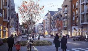 Eine moderne Stadtstraße mit mehrstöckigen Wohngebäuden, einem Baumallee und Fußgängern.