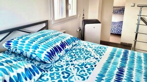 A bedroom with a bed, a window, a wardrobe, and a view of another room. - Villa in St-Raphaël with private spa, enclosed garden and terrace - 5 min from the beach (Saint-Raphaël)