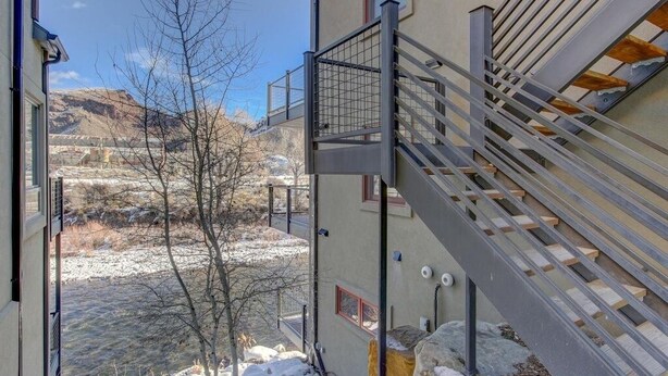 A modern building with a staircase leading to a balcony.