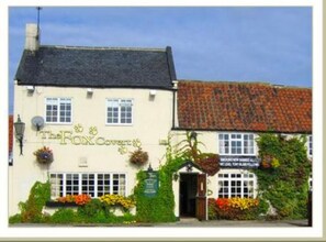 Traditional English pub with a classic facade and welcoming entrance.