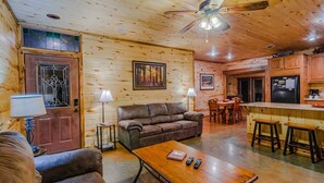 A cozy log cabin interior with a living room, kitchen, and dining area. - At Last, you can enjoy life with all the comforts of your own home on your stres (Broken Bow)