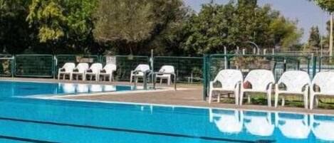 Seasonal outdoor pool, pool umbrellas, pool loungers