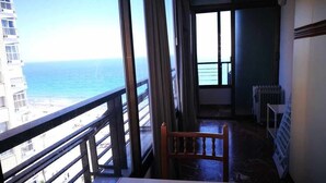 A balcony with a view of the ocean and a building across the water. - First Line of Levante Beach (Benidorm)