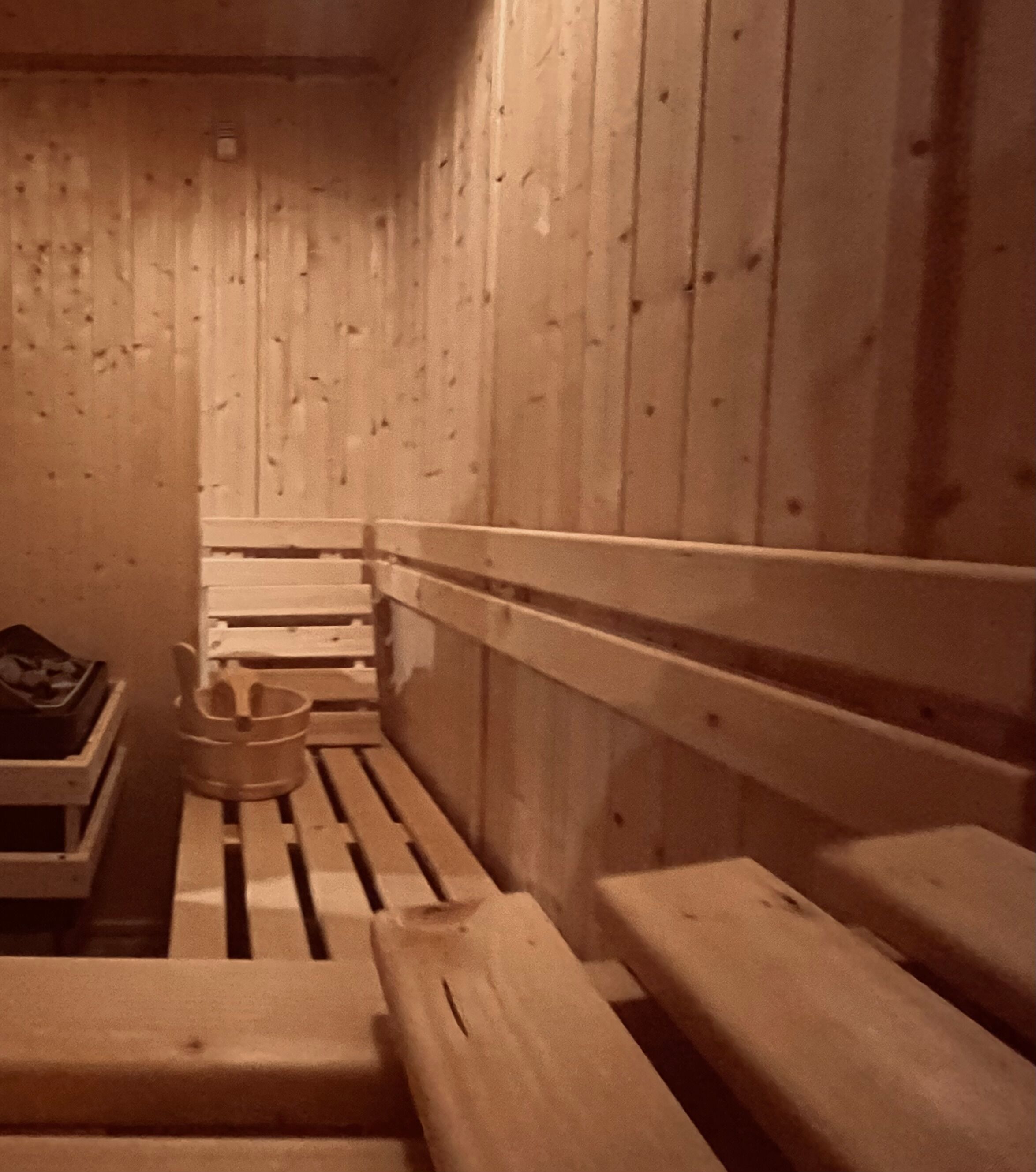 A sauna with wooden benches and a bench seat.