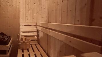 A sauna with wooden benches and a bench seat.