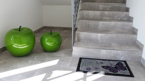 A staircase with a marble finish and a framed butterfly artwork at the bottom. - Entire apartment on the first floor (Piumazzo)