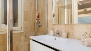 A modern bathroom with a glass shower enclosure, a white sink, and a large mirror. - The dock of Villa Sardagna (blevio)