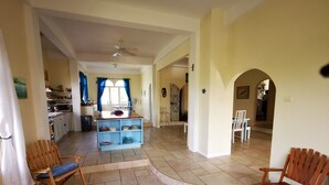 A spacious living area with a kitchen, dining table, and seating. - Casa Clara | 6BR Villa with Pool & Ocean View | Sleeps 12, Bacolet Tobago (Tobago)