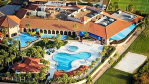 An aerial view of a resort with multiple swimming pools, a tennis court, and a large landscaped area. - Platinum Presidential Lock-Off Villa on the Lake-Westgate Lakes Orl. Sleeps 16 (Orlando)